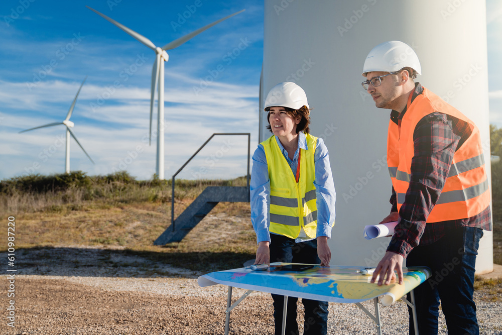 Engineers working at alternative renewable wind energy farm - Sustainable energy industry concept