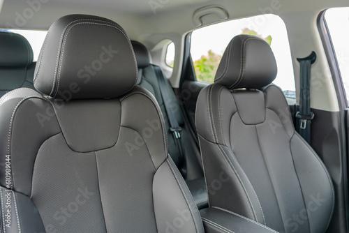Car Inside. Interior of prestige modern car. Comfortable leather seats. Black perforarated leather cockpit. © gargantiopa