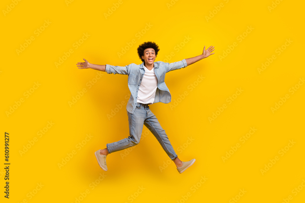 Full body portrait of excited carefree person jumping flight have good mood isolated on yellow color background