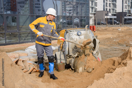 construction worker with shovel and bucket on construction site  of new building