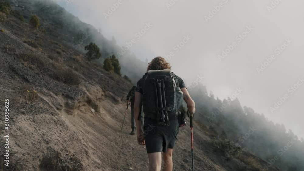 Hiking - Hiker With Poles Hiking Through The Steep Slopes To Acatenango Volcano In Guatemala. - rear handheld Hiking - Hiker With Poles Hiking Through The Steep Slopes To Acatenango Volcano In Guatemala. - rear handheld