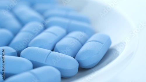 Heap of Blue pills close up, rotation. Pharmaceutical Industry. The medicine concept photo