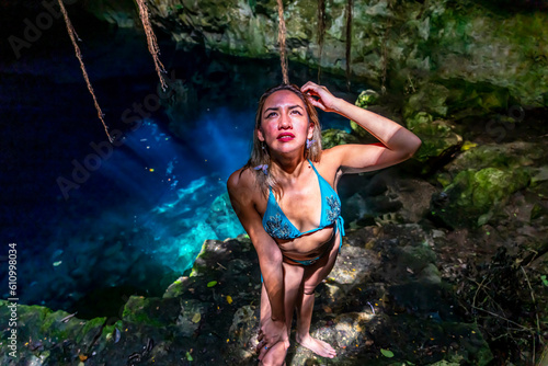 A Lovely Latin Model Enjoys The Beautiful Waters In The Cenotes Near Cuzama, Yucatan, Mexico photo