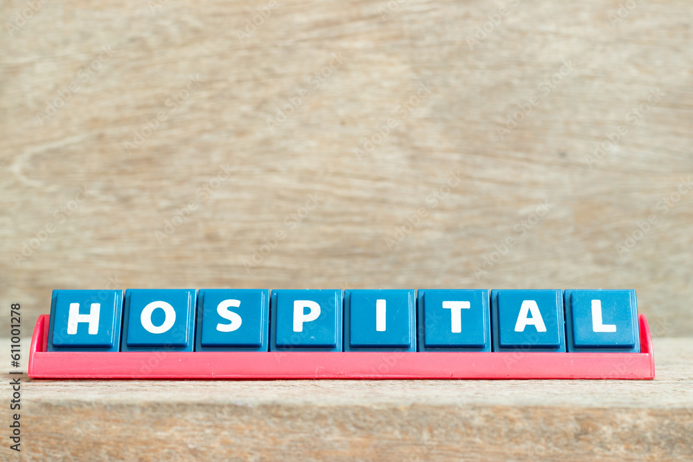 Obraz premium Tile alphabet letter with word hospital in red color rack on wood background
