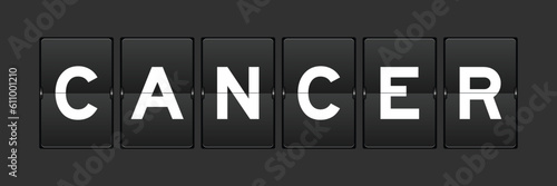 Black color analog flip board with word cancer on gray background