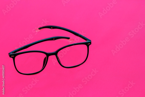 glasses with black frames isolated on pink background