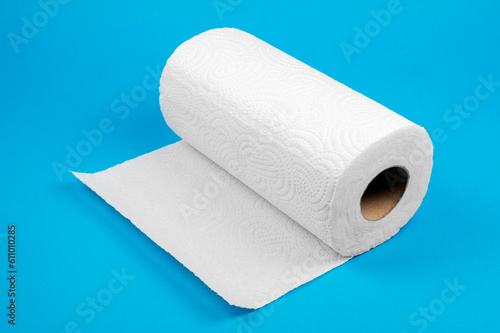 White roll paper towels on blue background