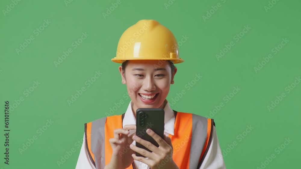 Close Up Of Asian Female Engineer With Safety Helmet Using Smartphone And Looking Around While Standing In The Green Screen Background Studio
Close Up Of Asian Female Engineer With Safety Helmet Using Smartphone And Looking Around While Standing In The Green Screen Background Studio