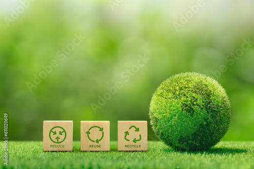  Words reduce reuse recycle on a wooden cube with a green world for saving the world, the Environmental concept of ecological waste management, and a sustainable and economical lifestyle.