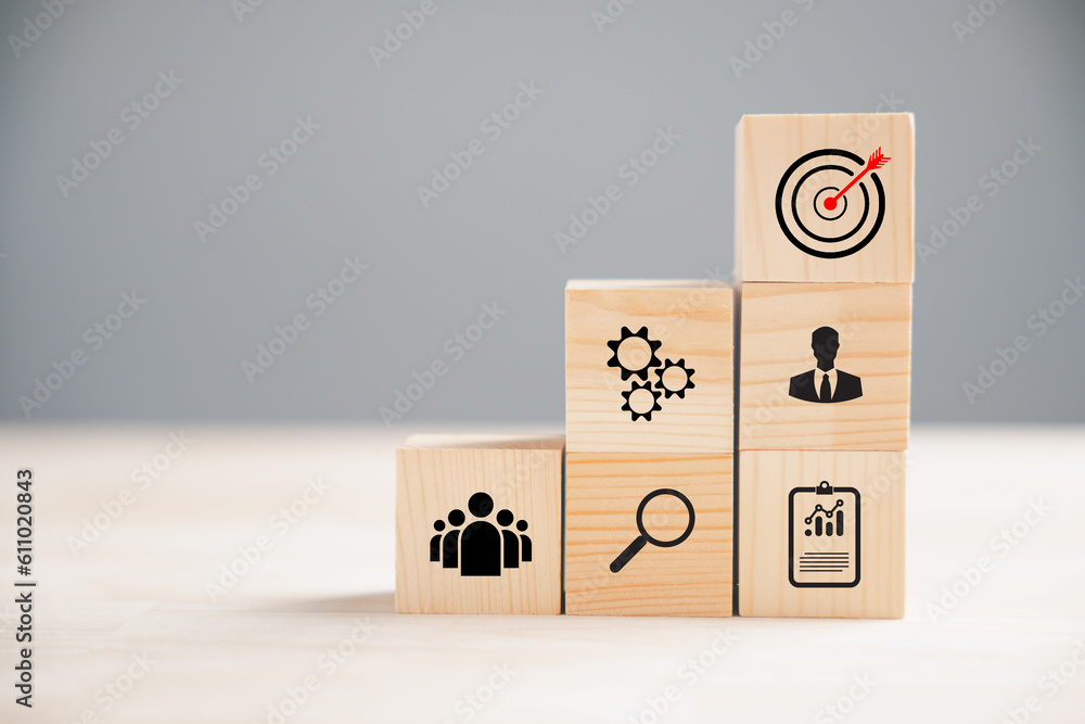 Wooden block cude step on a table with Action Plan, Goal, and Target icons. Success and business target concept. Project management and company strategy for professional growth. - obrazy, fototapety, plakaty 