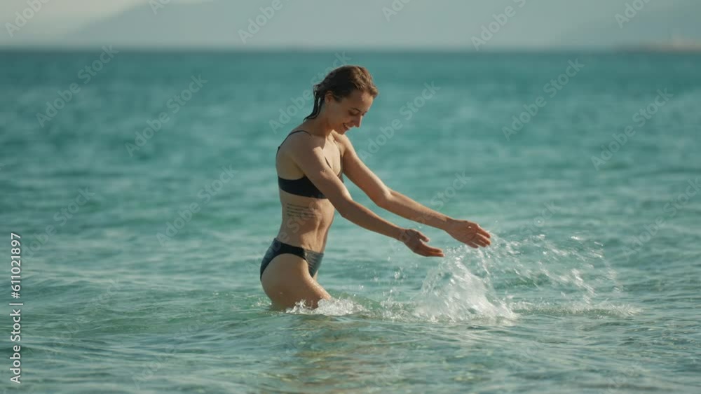 Outdoor shot of smiling young female model enjoying at sea beach against blue sky. Woman having fun out on a summer day. Outdoor shot of smiling young female model enjoying at sea beach against blue sky. Woman having fun out on a summer day.