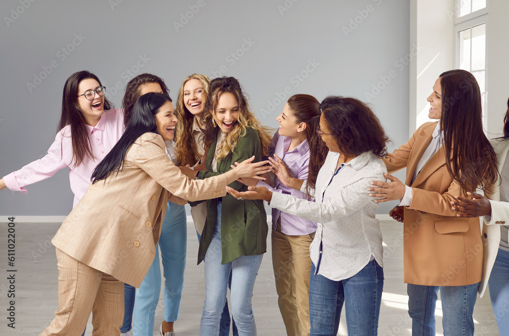 Group of happy young beautiful diverse multiethnic business women hugging and congratulating their friend on achieving success. Success, team, joy, female friendship concept Group of happy young beautiful diverse multiethnic business women hugging and congratulating their friend on achieving success. Success, team, joy, female friendship concept