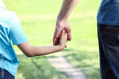 hands parent and child walking