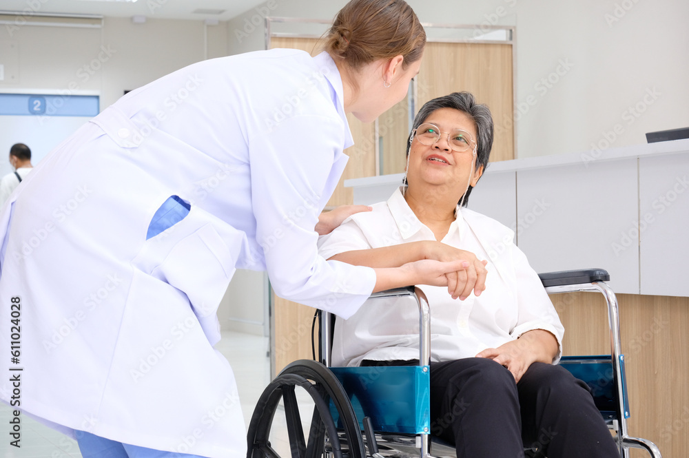female doctor caring for an elderly woman patient sitting in a wheelchair medical concept. female doctor caring for an elderly woman patient sitting in a wheelchair medical concept.