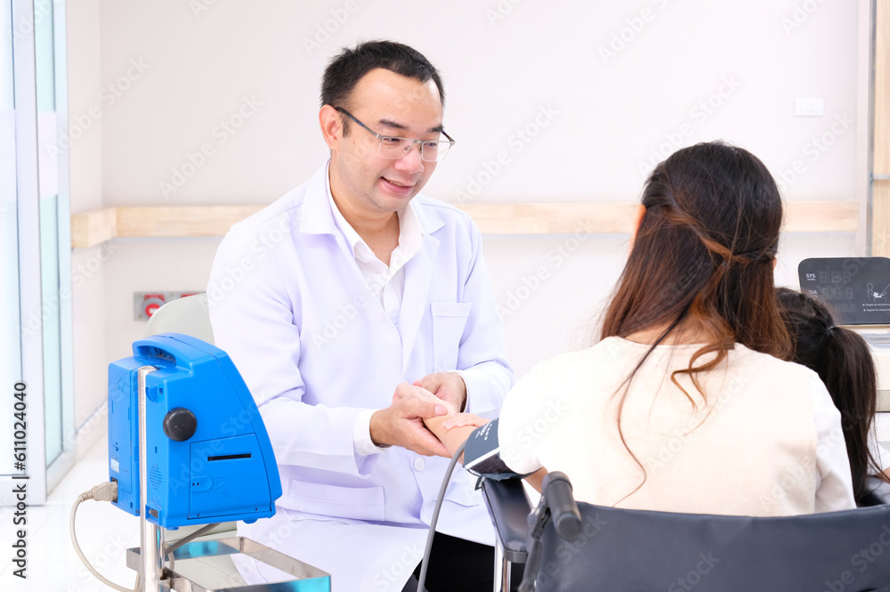 Asian male doctor measuring blood pressure for a female patient. Asian male doctor measuring blood pressure for a female patient.