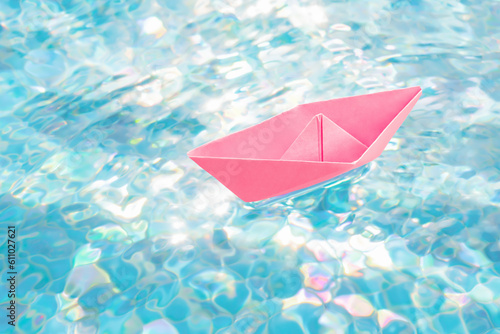 Abstract boat travel concept paper ship origami boat toy paper sailboat. Floating in water pink paper boat water abstract ship symbol. Hope concept dream future concept freedom water surface ripples