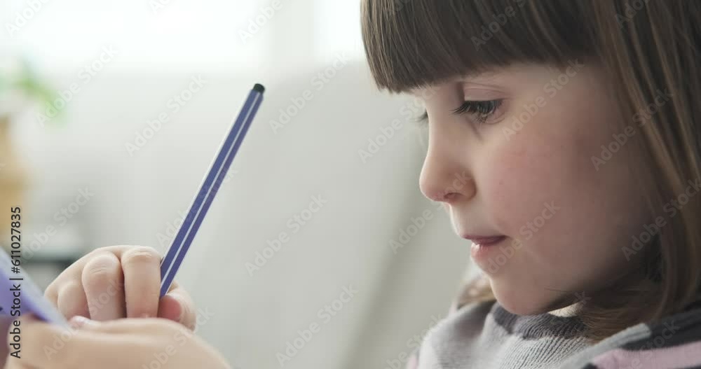 A young Caucasian preschool girl as she sits on the living room sofa, with a notebook in front of her, she fearlessly wields her markers, infusing her artwork with a burst of colors. A young Caucasian preschool girl as she sits on the living room sofa, with a notebook in front of her, she fearlessly wields her markers, infusing her artwork with a burst of colors.
