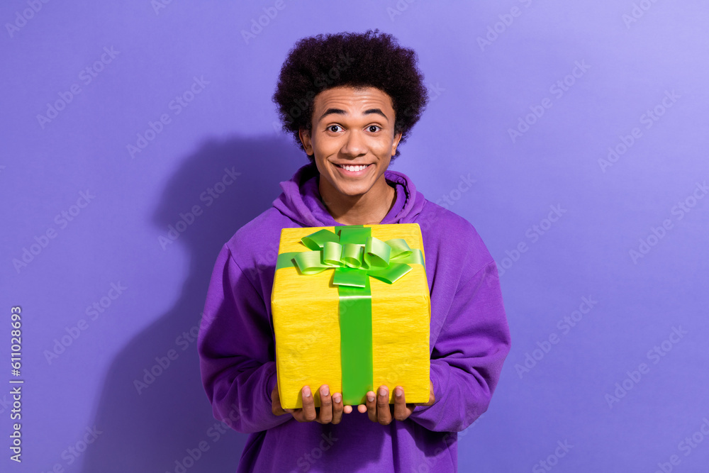 Photo of excited funky person beaming smile hands hold receive desirable giftbox isolated on violet color background Photo of excited funky person beaming smile hands hold receive desirable giftbox isolated on violet color background