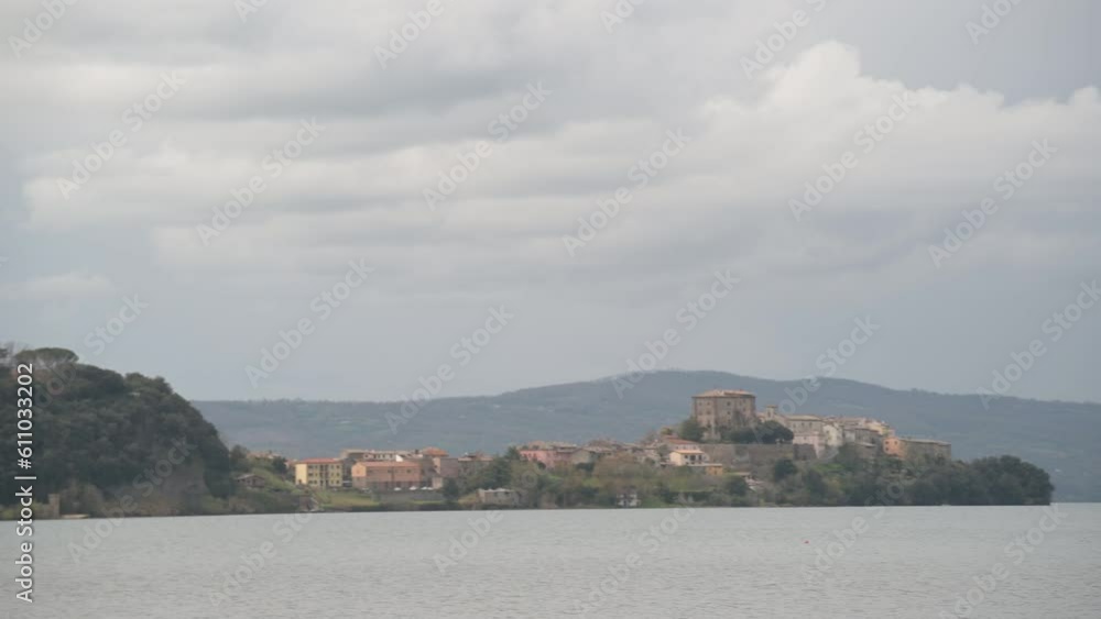 The promontory on Lake Bolsena on which Capodimonte is located, Italy, seen from Marta The promontory on Lake Bolsena on which Capodimonte is located, Italy, seen from Marta