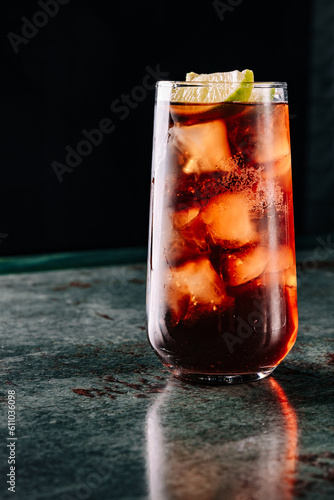 Fresh made coktail Cuba Libre with brown rum, cola and lemon 