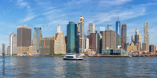 New York City skyline of Manhattan with World Trade Center skyscraper and ferry panorama in the United States