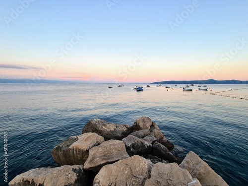 Amazing sunset seascape, beauty of nature. Scenic view of the sea, rocky seacoast , golden colored sky and sun, outdoor travel background, Croatia