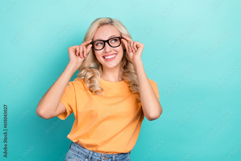Portrait of friendly adorable person wear stylish t-shirt fingers touch glasses look empty space isolated on turquoise color background Portrait of friendly adorable person wear stylish t-shirt fingers touch glasses look empty space isolated on turquoise color background