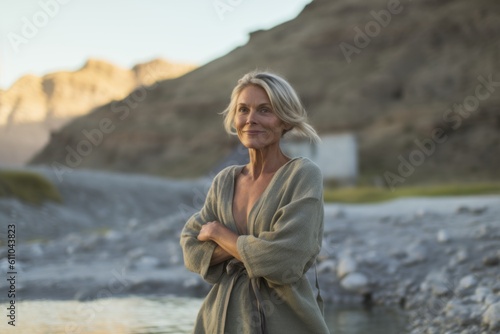 Full-length portrait photography of a tender mature woman walking against a scenic hot springs background. With generative AI technology