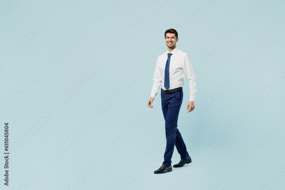 Full body happy young employee IT business man corporate lawyer wear classic formal shirt tie work in office walking going look camera isolated on plain pastel light blue background studio portrait.