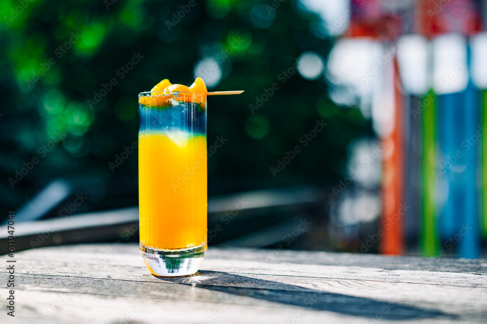 Fresh cold mango cocktail, mango juice smoothie in glass outdoors - obrazy, fototapety, plakaty 