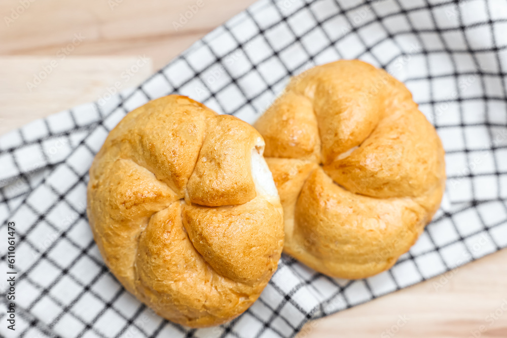 Kaiser rolls with napkin on table, closeup Kaiser rolls with napkin on table, closeup