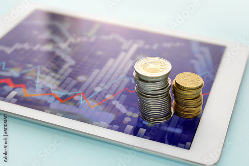 Coins and tablet computer w...
