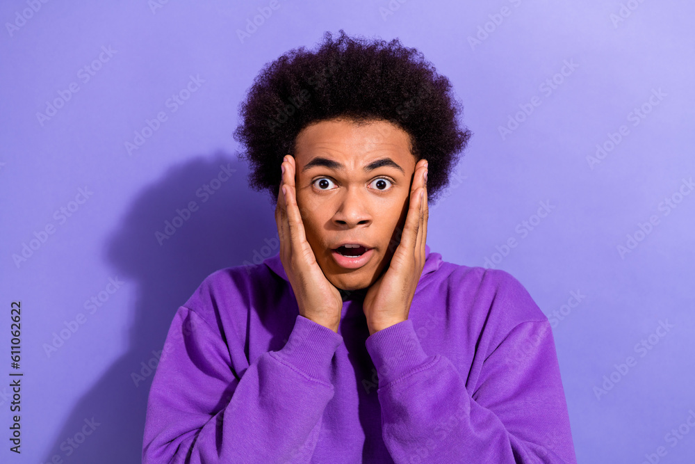 Portrait of impressed speechless man arms touch cheekbones open mouth cant believe isolated on purple color background Portrait of impressed speechless man arms touch cheekbones open mouth cant believe isolated on purple color background