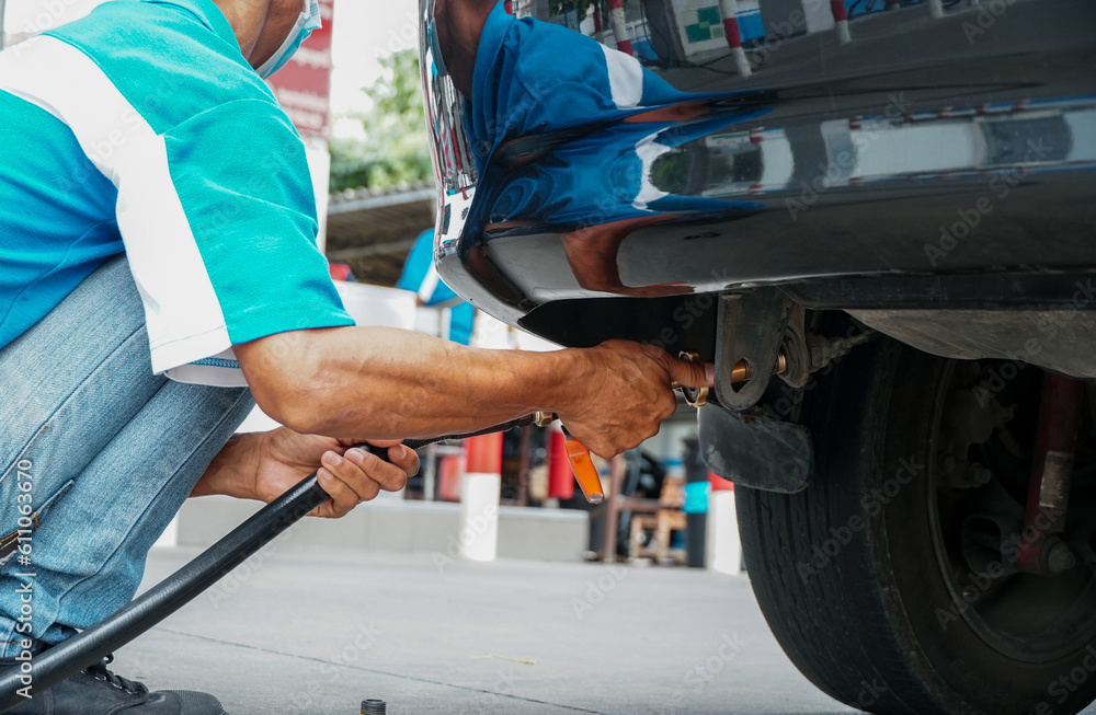 Man filling LPG injector, Liquid Petroleum Gas service pump. Man filling LPG injector, Liquid Petroleum Gas service pump.
