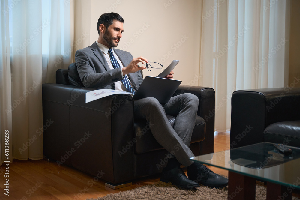 Middle-aged male works with documents in the relax zone
