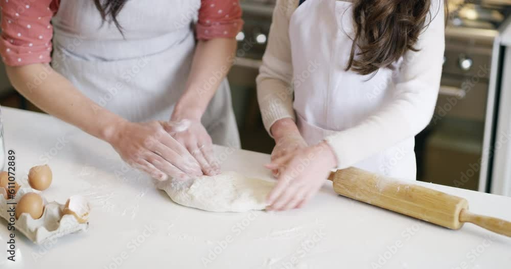 Mother baking with pastry with her child in the kitchen for a party, celebration or handmade dessert. Home, weekend and closeup of woman rolling dough with her girl kid to bake sweet treats together. Mother baking with pastry with her child in the kitchen for a party, celebration or handmade dessert. Home, weekend and closeup of woman rolling dough with her girl kid to bake sweet treats together.