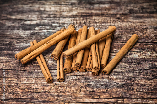 Close-up of ceylon cinnamon sticks on wooden table, top view. Rustic style of Sri lankan cinnamon sticks, natural spices for advertising banner or poster. Delicious healthy concept. Copy ad text space