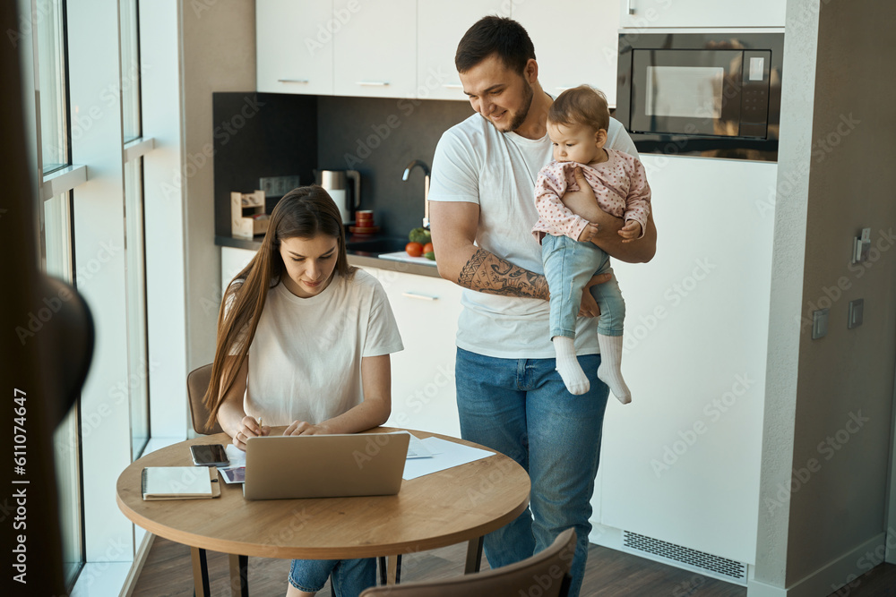 Modern woman works remotely in the kitchen Modern woman works remotely in the kitchen