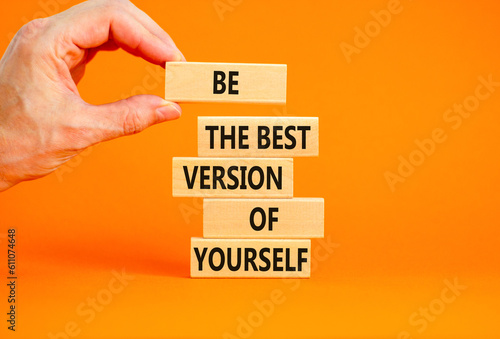 Motivational inspirational symbol. Concept words Be the best version of yourself on wooden block. Beautiful orange background Businessman hand. Business motivational inspirational concept. Copy space.