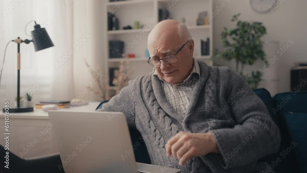 Portrait of senior man using laptop at home, technology, modern grandpa's life Portrait of senior man using laptop at home, technology, modern grandpa's life