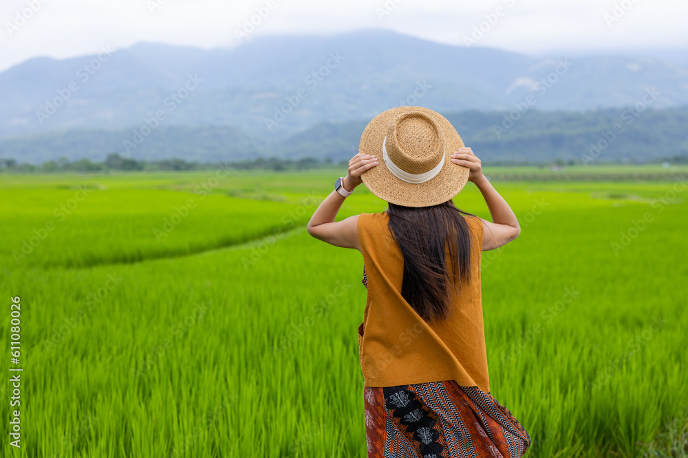 Travel woman enjoy the rice field scenery view in countryside