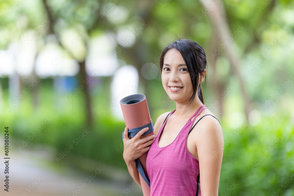 Sport woman hold with yoga mat at park Sport woman hold with yoga mat at park