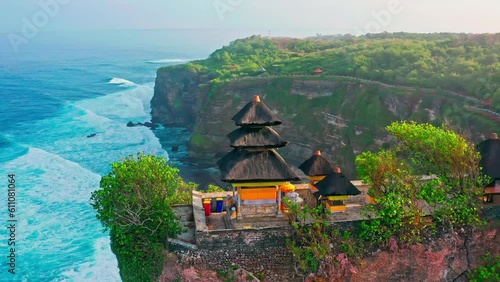 Uluwatu Temple one of six key Bali temple perched on top mountain cliff on nature background Bali, Indonesia 4K Aerial view