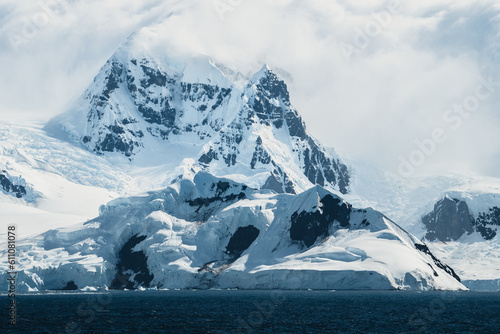 Beautiful snow-capped mountains with glaciers against the blue sky in Antarctica. Climate change and global warming concept. Arctic Greenland and ilulissat.