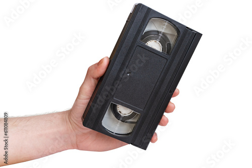 Vintage VHS cassette in hand. A man's hand holds a video cassette on a white background.