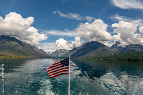 View of Lake McDonald Glacier National Park from a Boat Flying American Flag  photo