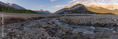 Wilderness view in Kananaskis with mountains, creek, stream running through large mountain valley, pass area in summer time with background, wild view in Canada, Banff National Park.  photo