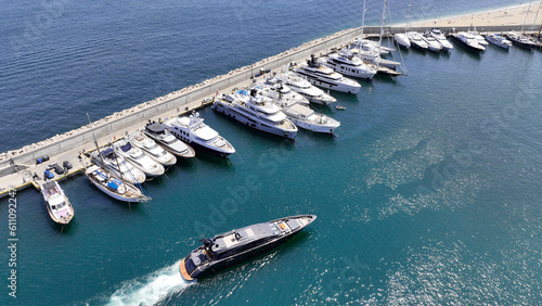 Aerial drone photo of beautiful yacht manoeuvring inside round port of Zea or Passalimani a safe anchorage in seaside area of Piraeus, Attica, Greece © aerial-drone
