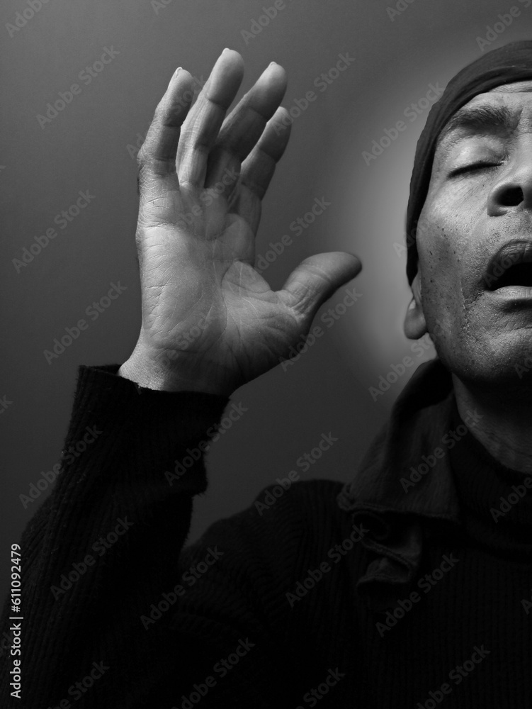 man praying to god with hands together Caribbean man praying on black background with people stock photos stock photo man praying to god with hands together Caribbean man praying on black background with people stock photos stock photo