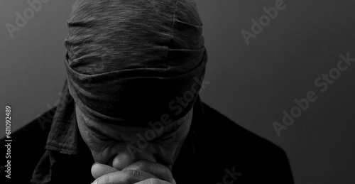 man praying to god with hands together Caribbean man praying on black background with people stock photos stock photo	